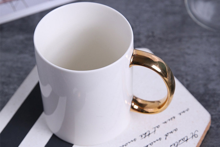 white ceramic coffee mugs with gold handles