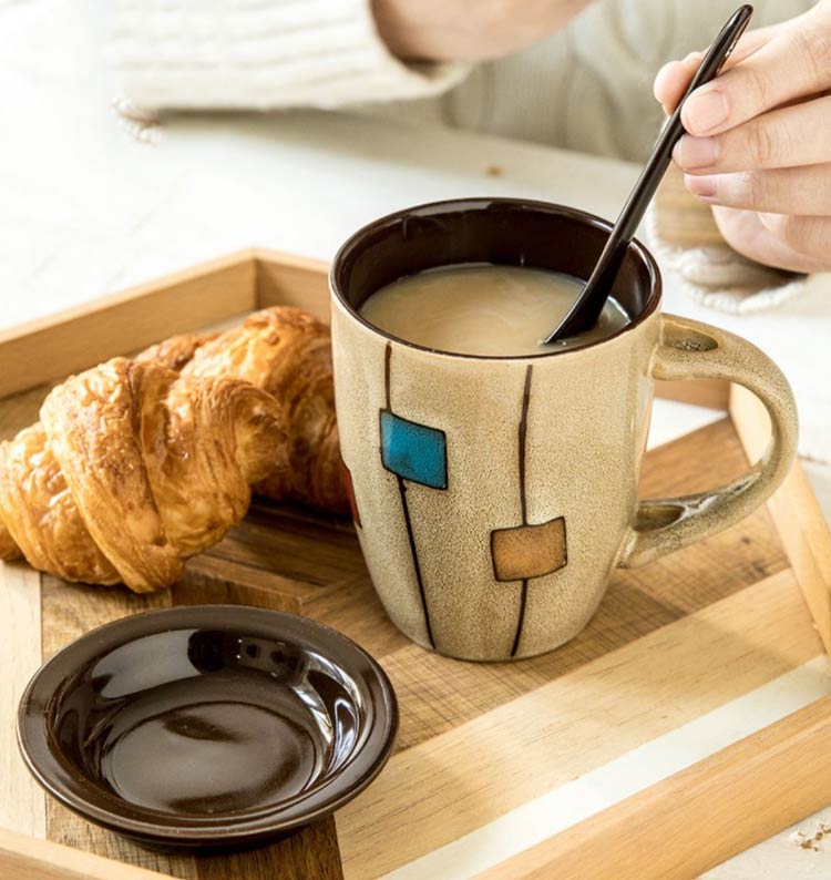 hand-painted ceramic cup with spoon