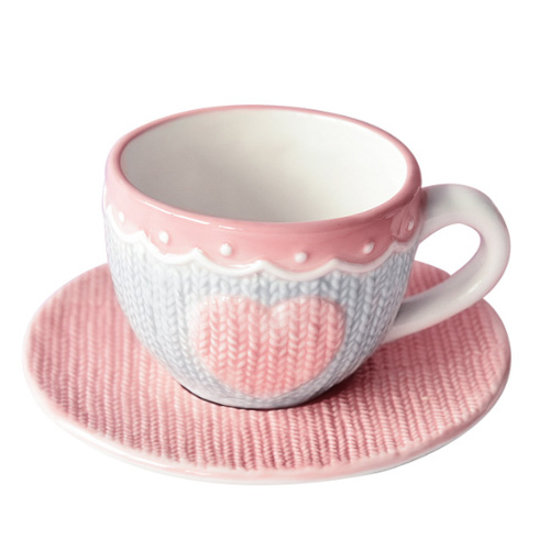pink ceramic coffee cup and saucer