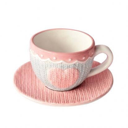 pink ceramic coffee cup and saucer with embossed design