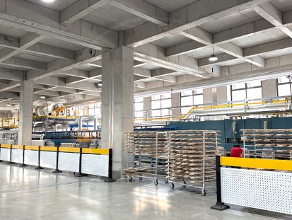 Modern ceramic factory with automated production lines and ceramic tableware racks